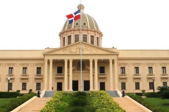 Palacio Nacional with a Dominican flag on top, featuring a large dome and columns.