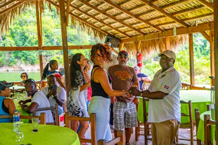 a group of people standing around a table