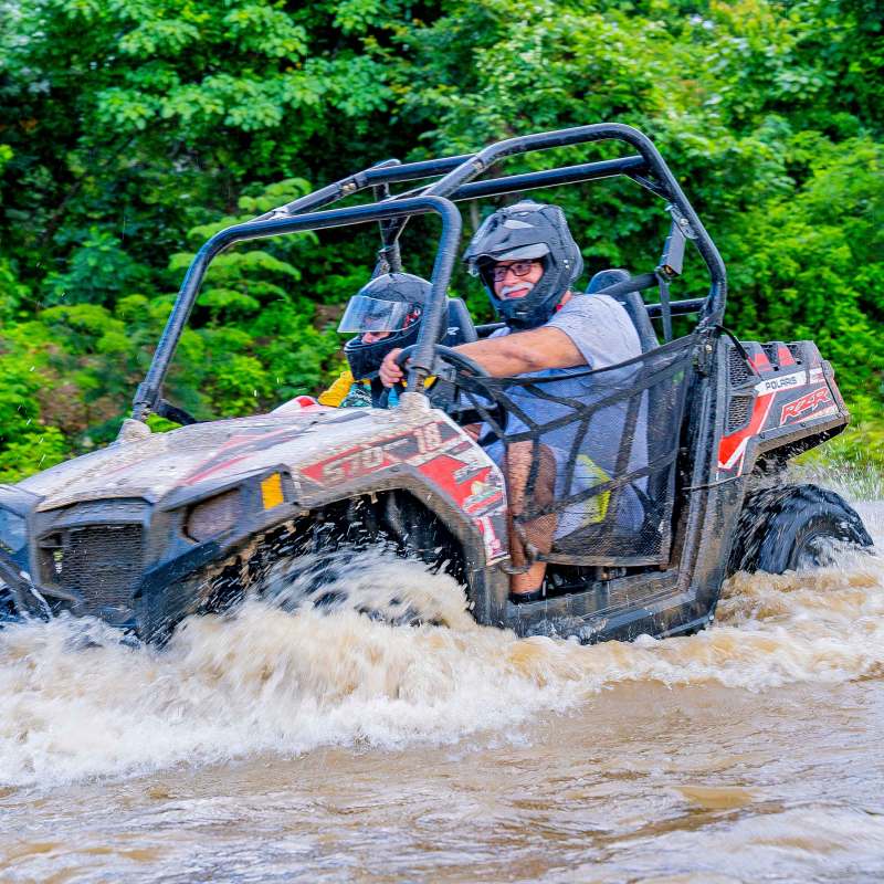 a man riding a bike down a dirt road