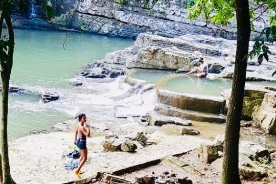 a person standing next to a river