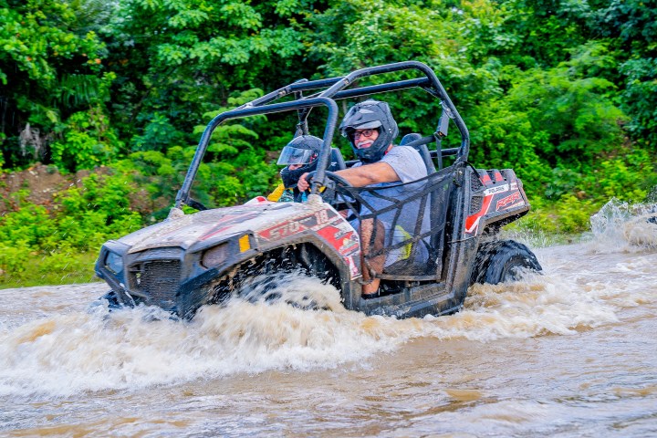 a man riding a bike down a dirt road