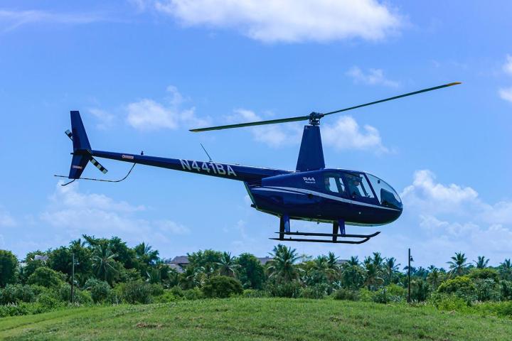 a helicopter flying over a field