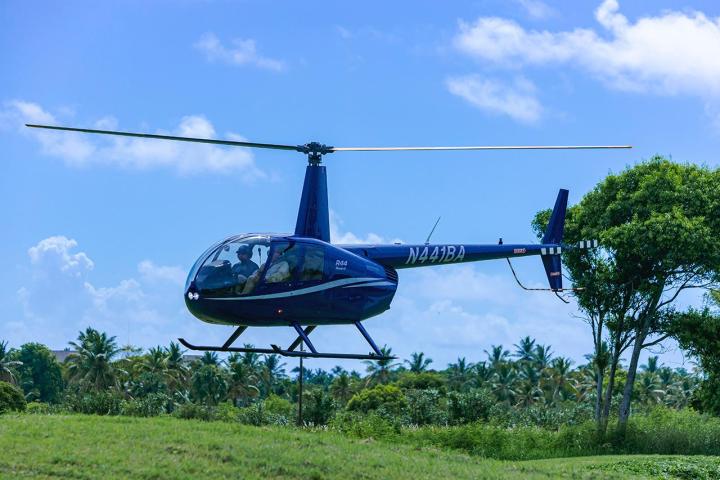 a helicopter flying over a field