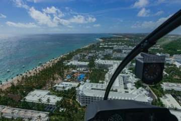 Aerial view of coastal resort with beach, ocean, and buildings.