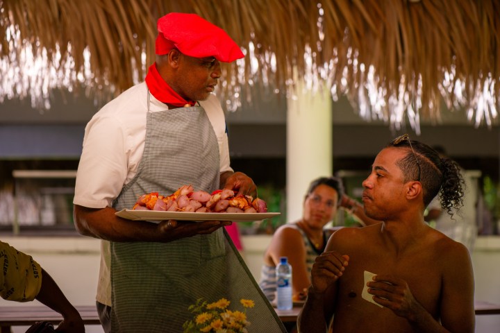 a person holding a glass of orange juice